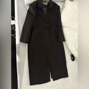 Because of Alex coat long and has one button on the side with split.